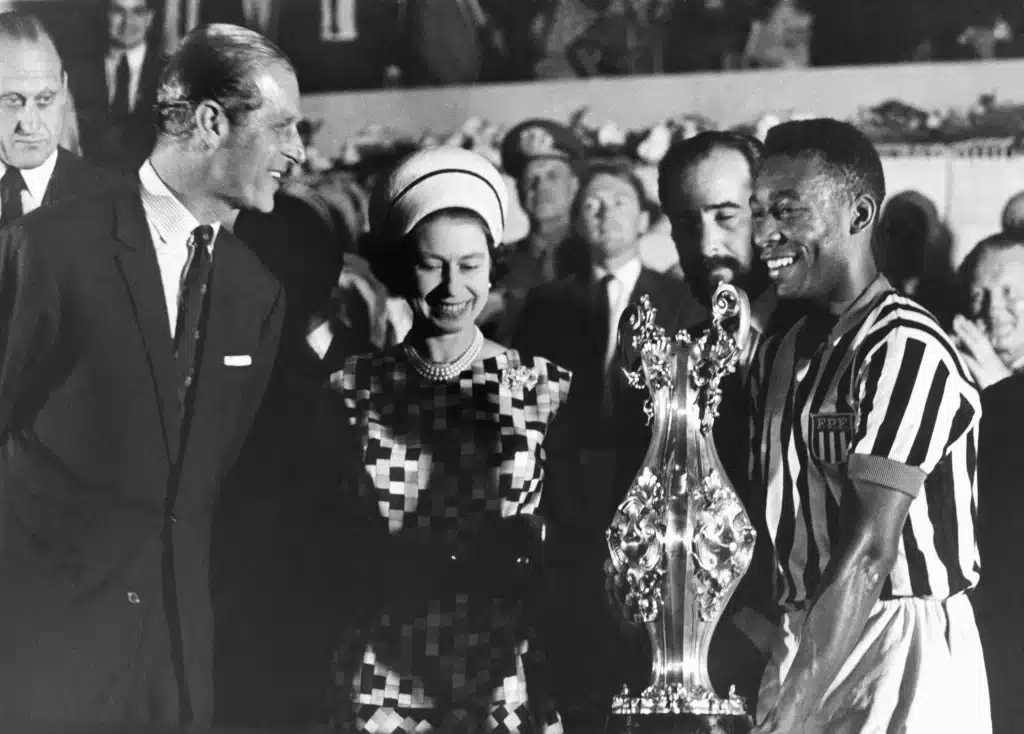 Britain-Queen-Elizabeth-II-with-Prince-Philip-present-a-cup-to-Pele-right-at-a-stadium-in-Rio-de-Janeiro-during-a-state-tour-of-South-America-in-1968