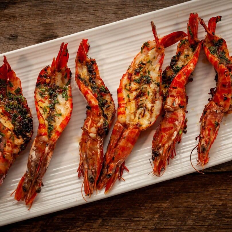 Baked garlic prawns with roasted peppers & gremolata toasts Recipe